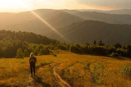 a woman rests after a hike in the mountainsの写真素材
