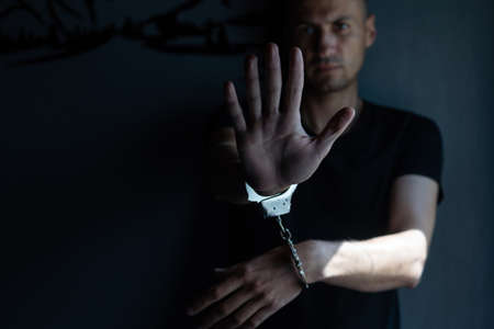 male hands in handcuffs black backgroundの写真素材