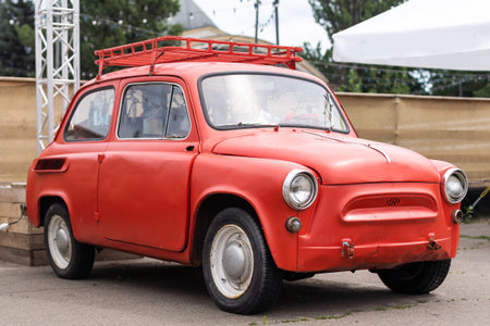 Vintage red tiny car in a parking, 25 August 2022 - Ukraine, Kyiv.