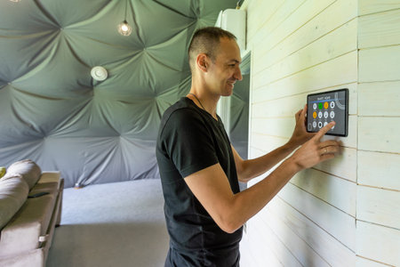 Smart home control on tablet. Interior of living room in the backgroundの写真素材