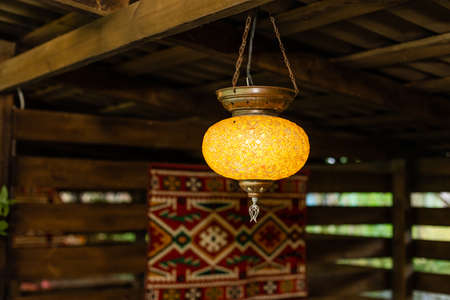 Decorating hanging lantern lamps in wooden interior.の写真素材