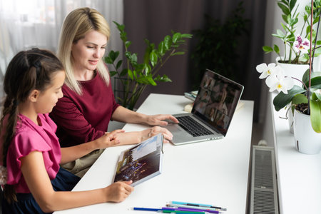 Cute little girl with therapist. Young woman teacher and child on private lesson.