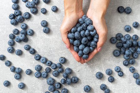large blueberry in female handsの写真素材