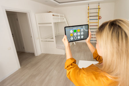 Woman using smart wall home control system.