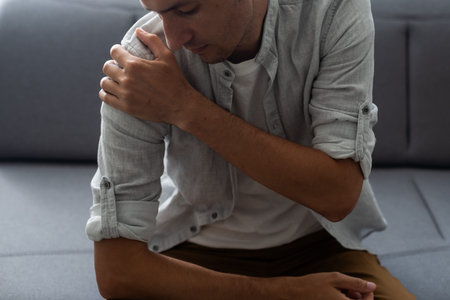 Shoulder pain. The mans shoulder hurts. A Band-Aid.の写真素材