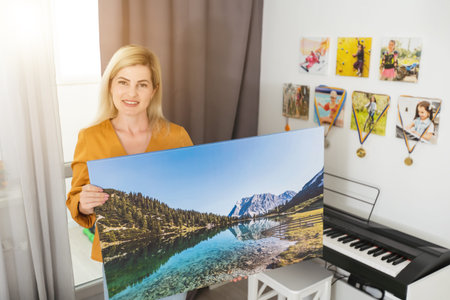 Canvas prints. woman holding photo canvasの写真素材