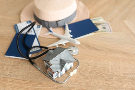 Medical tourism concept. Stethoscope with passport and tickets, toy planeの写真素材