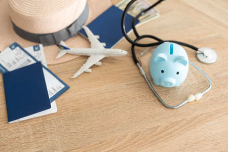 Medical tourism concept. Stethoscope with passport and tickets, toy planeの写真素材