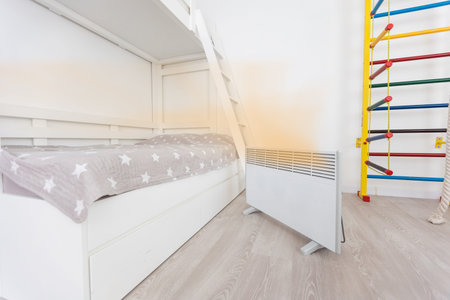 Modern electric heater in stylish room interior.