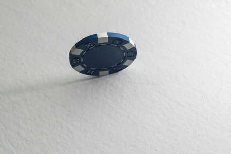 Blue casino chip isolated on white. Poker game.の写真素材