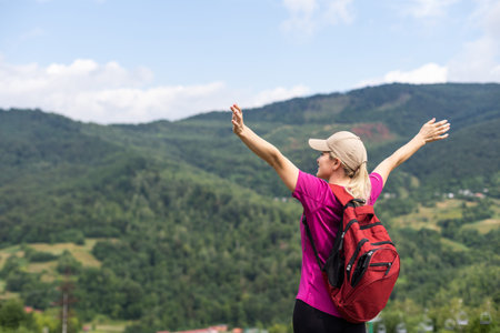 Girl Traveler hiking with backpack at rocky mountains landscape Travel Lifestyle concept adventure...
