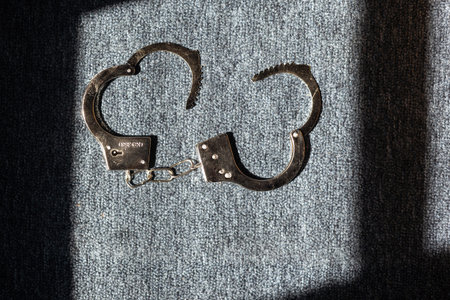 Classic chain handcuffs on black background