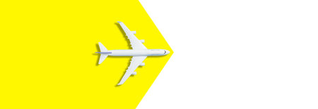 Model white plane, airplane on yellow background. Top view, flat lay. Travel, vacation concept.