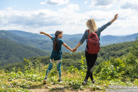 Mother and Daughter enjoying the view after a mountain hikeの写真素材