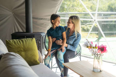 Woman mama in light clothes have fun with cute child girl. Mother and little kid daughter. Mothers Day, love family, parenthood childhood conceptの写真素材