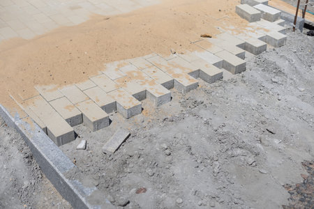 Stone blocks laying is on sand base. Sidewalk device.の写真素材