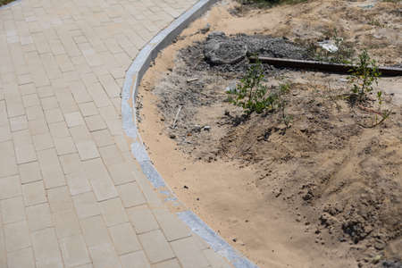 Stone blocks laying is on sand base. Sidewalk device.の写真素材