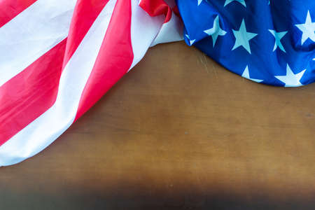 Top view overhead America United States flag, memorial remembrance and thank you of hero, studio shot with copy space on wooden table background, USA holiday Veterans or Independence day concept.の写真素材