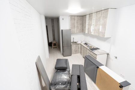 Modern black and white cloth sofa assembly, assembling parts of sofa on brown wooden floor with paper instructionの写真素材