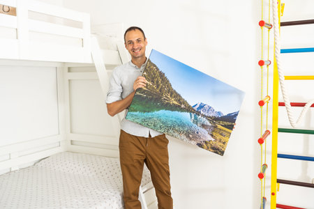Modern Home Interior And Domestic Decor. a man is holding a photo canvasの写真素材