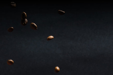heap of coffee beans on black background