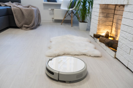robotic vacuum cleaner on laminate wood floor smart cleaning technologyの写真素材