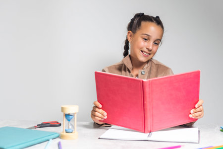 Little Girl doing homework on deskの写真素材