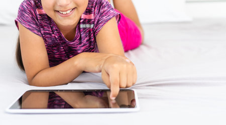 Happy little girl using tablet computer