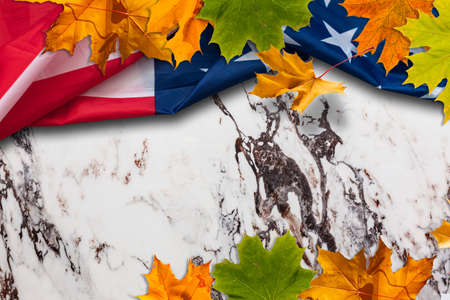 fall leaves sit on on American flagの写真素材
