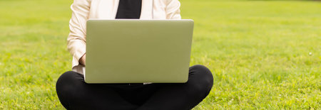 Young woman using laptop in the parkの写真素材