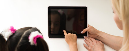 picture of mother and daughter with tablet pcの写真素材