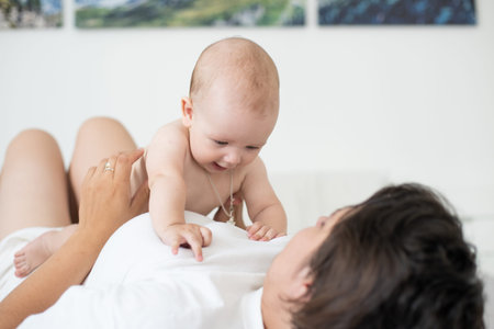 Portrait of a mother with her 6 months old baby, top view point