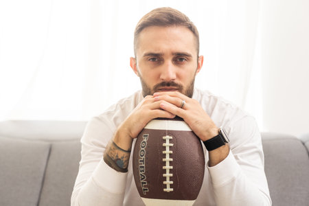 Rugby player holding a rugby ball on a white background