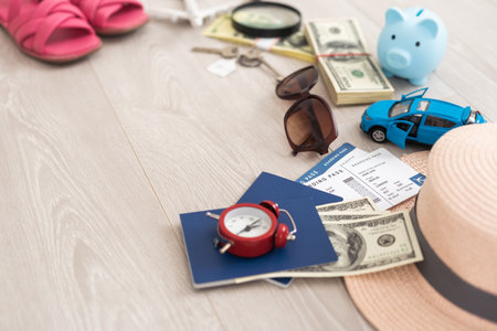 dollars, piggy bank, alarm clock, hat, glasses. Time to go on holiday. Things for summer trip.の写真素材