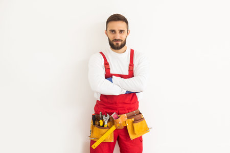 Man builder in a robe, overalls on a white background. Isolate, copy space