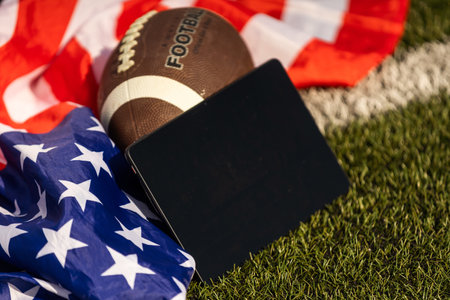 american football ball and tablet, american flagの写真素材