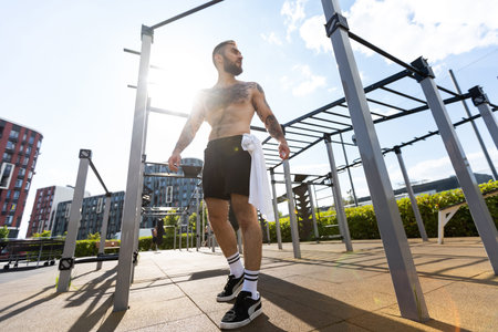 a man trains on the street with exercise machines