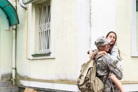 Soldier in camouflage meeting his daughter outdoorsの写真素材