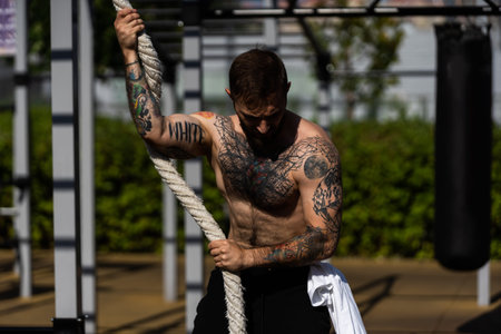 a man trains on the street with exercise machines