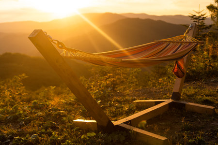 Empty hammok hanging in the mountains in summerの写真素材