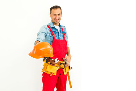 Serious Male Construction Worker with short black hair in uniform with arms folded - Isolated