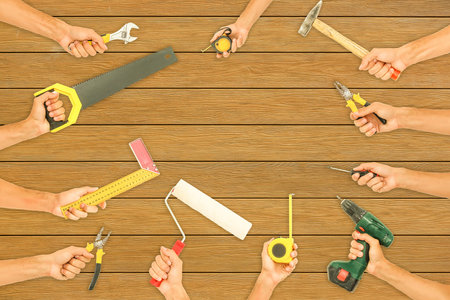 grungy old tools on a wooden background