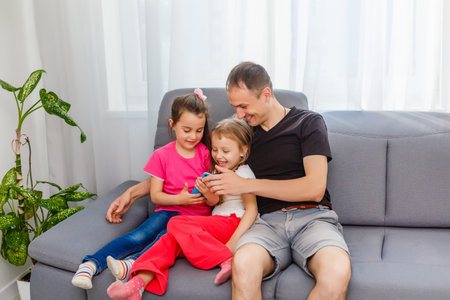 Smile! Young father and his little daughter phone