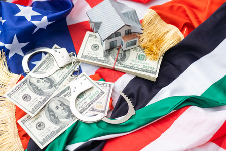 metal handcuff, american dollars cash over flag of USA and UAE flagsの写真素材