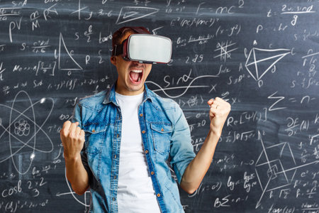 man in virtual glasses on the background of formulasの写真素材