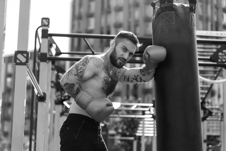 a man trains in boxing gloves on the streetの写真素材