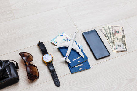 travel items are a compass, tickets, documents, money, a camera, a toy airplane. Planning of air travel, holidays, business trips. Advertising, banner.の写真素材