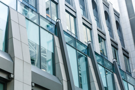 Modern building, office business center exterior. Grey wall, large windows. Angle view. Skyscaper...