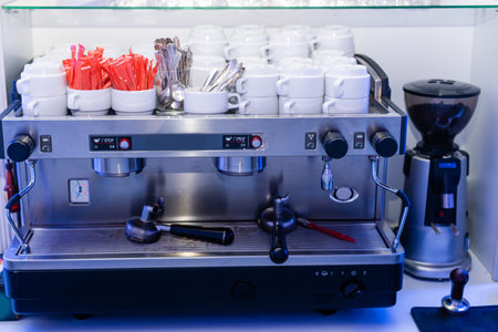 coffee machine preparing fresh coffee and pouring into red cups at restaurant, bar or pub