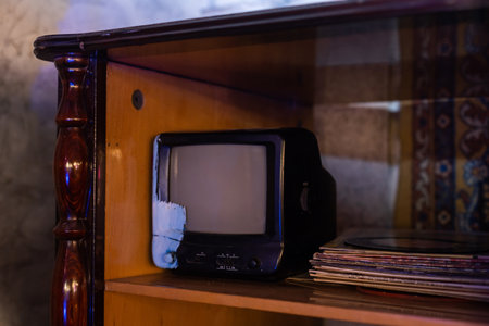 retro tv with wooden case in room with vintage wallpaper and parquetの写真素材